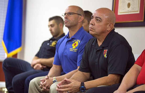 Angelo Aragon, right, president of the Professional Fire Fighters of Nevada, listens during a news conference at the International Association of Firefighters Union Hall, Local 1285, Tuesday, Oct. 3, 2017. Several firefighters who were off-duty and attending the Route 91 Harvest festival on Sunday shared their experiences.