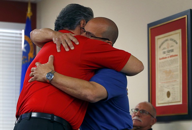 City of Las Vegas firefighter Benjamin Kole, left, gets a hug from Eric Littman, president of the Las Vegas Firefighters Local 1285, after speaking at the International Association of Firefighters Union Hall, Local 1285, Tuesday, Oct. 3, 2017. Kole was among many off-duty firefighters attending the Route 91 Harvest festival on Sunday when gunman Stephen Paddock opened fire on the crowd.