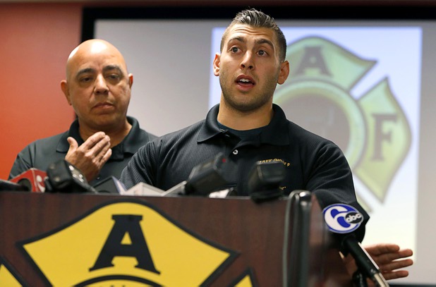 Angelo Aragon, left, president of the Professional Fire Fighters of Nevada, listens as Henderson firefighter Anthony Robone speaks during a news conference at the International Association of Firefighters Union Hall, Local 1285, Tuesday, Oct. 3, 2017. Robone's older brother Nick, an assistant hockey coach at UNLV, was hit by gunfire at the Route 91 Harvest festival on Sunday when gunman Stephen Paddock opened fire on the crowd.