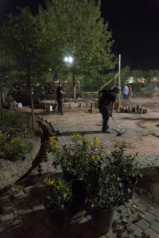 Volunteers work on a community healing garden being created in response to the Oct. 1 mass shooting, Thursday evening, Oct. 6, 2017. Jay Pleggenkuhle and Daniel Perez of Stonerose Landscapes organized the effort the day after the shooting. Through volunteers and donations, the garden should open on First Friday, five days after the tragic event. 