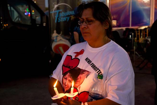 Gloria Avila holds back tears as she holds candles Friday Oct. 6, 2017, during a vigil at First Friday, for the memory of the victims in the Route 91 Havest Festiva. Avila's neice Denise Cohen and her boyfriend "Bo" Taylor were killed in the mass shooting.