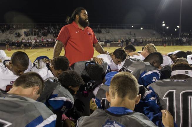Coronado and Basic players and coaches come together at midfield in a pregame tribute to Charleston Hartfield, the off-duty cop who died during Sundays shooting. His son, Ayzayah Hartfield, plays for Coronado on Friday, October 6, 2017.   .