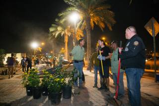 Jay Pleggenkuhle (green shirt, left) and Daniel Perez (green shirt, right) talk to volunteers onsite at a community healing garden being created in response to the Oct. 1 mass shooting, Thursday evening, Oct. 6, 2017. Jay Pleggenkuhle and Daniel Perez of Stonerose Landscapes organized the effort the day after the shooting. Through volunteers and donations, the garden should open on First Friday, five days after the tragic event.