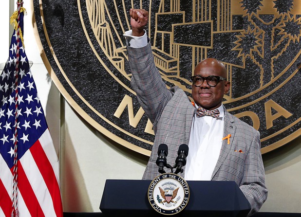 Pastor Michael Hatch gives a "Vegas Strong" salute in Las Vegas City Hall following a Unity Prayer Walk Saturday, Oct. 7, 2017.