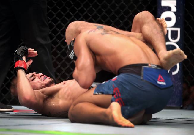 Lightweight Tony Ferguson chokes out Kevin Lee into submission during their UFC 216 fight at the T-Mobile Arena.