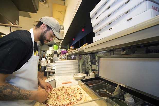 Jessop Jameson makes a pizza at Evel Pie, 508 E. Fremont St., in downtown Las Vegas Sunday, Oct. 8, 2017. The pizza shop, in collaboration with the Helpful Hoodlums charity group, is donating pizza and drinks to first responders in the wake of the Oct. 1 Route 91 Harvest festival mass shooting.