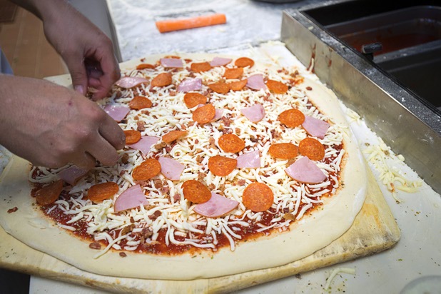 Jessop Jameson makes a pizza at Evel Pie, 508 E. Fremont St., in downtown Las Vegas Sunday, Oct. 8, 2017. The pizza shop, in collaboration with the Helpful Hoodlums charity group, is donating pizza and drinks to first responders in the wake of the Oct. 1 Route 91 Harvest festival mass shooting.