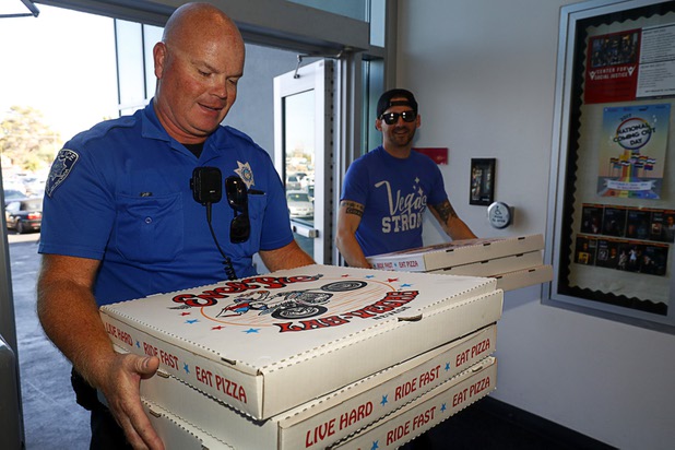 UNLV Police officer Brett Goff and volunteer Jared Stinson bring Evel Pie pizzas into the UNLV student union Sunday, Oct. 8, 2017. The pizza shop, in collaboration with the Helpful Hoodlums charity group, donated the food and drink to UNLV police officers and to students who were nervous about leaving campus following the Oct. 1 Route 91 Harvest festival mass shooting.
