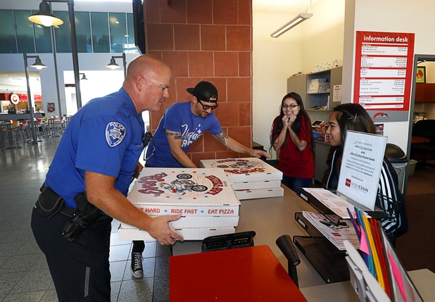 UNLV Police officer Brett Goff and volunteer Jared Stinson bring Evel Pie pizzas into the UNLV student union Sunday, Oct. 8, 2017. The pizza shop, in collaboration with the Helpful Hoodlums charity group, donated the food and drink to UNLV police officers and to students who were nervous about leaving campus following the Oct. 1 Route 91 Harvest festival mass shooting.
