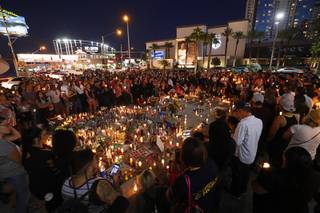 Hundreds of people attend a vigil, marking the one-week anniversary of the Oct. 1 mass shooting, at Sahara Avenue and The Strip Sunday, Oct. 8, 2017.