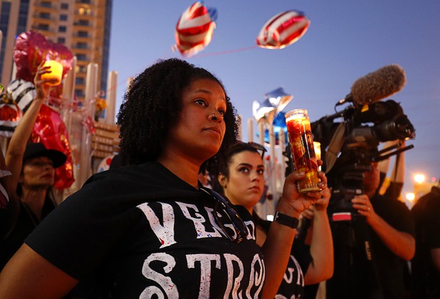 Krystle Egemba of Las Vegas holds a candle during a vigil, marking the one-week anniversary of the Oct. 1 mass shooting, at Sahara Avenue and The Strip Sunday, Oct. 8, 2017.