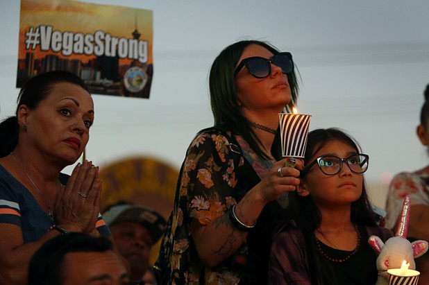 Sarah Hendricks and her daughter Harlow, 9, attend a vigil, marking the one-week anniversary of the Oct. 1 mass shooting, at Sahara Avenue and The Strip Sunday, Oct. 8, 2017.