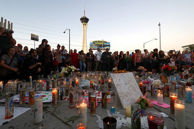 Hundreds of people attend a vigil, marking the one-week anniversary of the Oct. 1 mass shooting, at Sahara Avenue and The Strip Sunday, Oct. 8, 2017.
