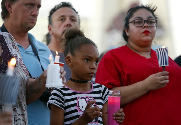 People attend during a vigil, marking the one-week anniversary of the Oct. 1 mass shooting, at Sahara Avenue and The Strip Sunday, Oct. 8, 2017.
