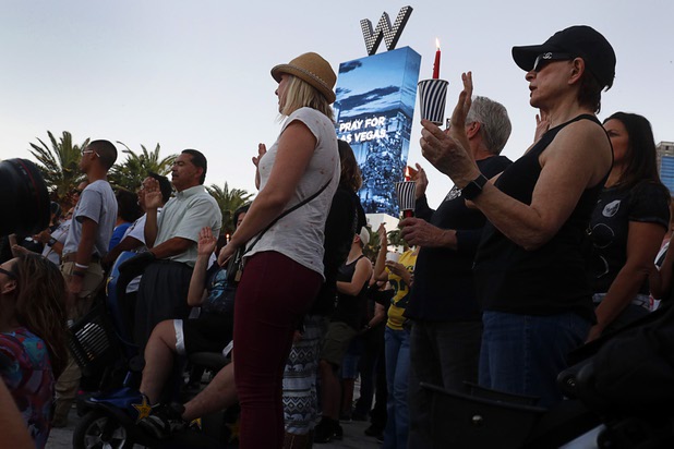 People attend during a vigil, marking the one-week anniversary of the Oct. 1 mass shooting, at Sahara Avenue and The Strip Sunday, Oct. 8, 2017.