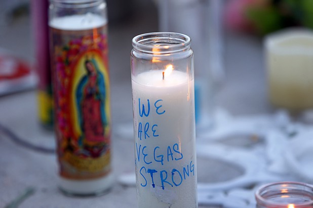 Candles are shown at a makeshift memorial during a vigil, marking the one-week anniversary of the Oct. 1 mass shooting, at Sahara Avenue and The Strip Sunday, Oct. 8, 2017.