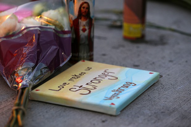 Flowers and a plaque are left at a makeshift memorial during a vigil, marking the one-week anniversary of the Oct. 1 mass shooting, at Sahara Avenue and The Strip Sunday, Oct. 8, 2017.
