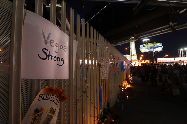A Vegas Strong sign is left in a fence by a makeshift memorial during a vigil, marking the one-week anniversary of the Oct. 1 mass shooting, at Sahara Avenue and The Strip Sunday, Oct. 8, 2017.