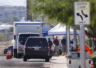 Investigators are shown by a box truck on Giles Street near the Las Vegas Village Sunday, Oct. 8, 2017. Officials announced the process for return of personal effects from the Oct. 1 mass shooting at the Route 91 Harvest music festival.