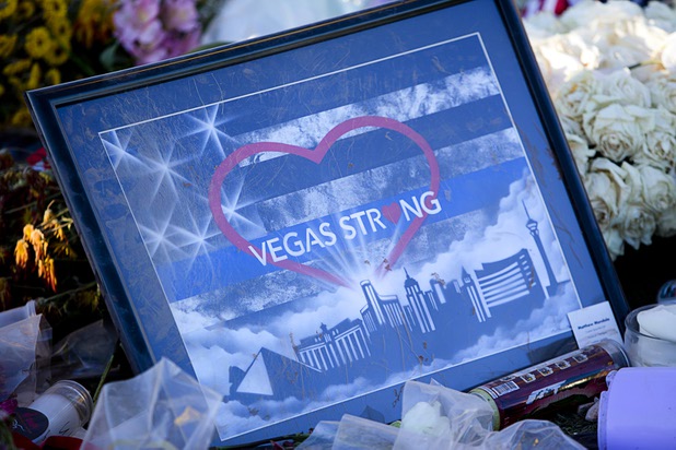 A "Vegas Strong" illustration is shown among flowers under the "Welcome to Las Vegas" sign Monday, Oct. 9, 2017.