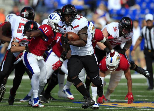 Texas Tech running back Desmond Nisby (32) runs for a 47-yard touchdown during the first half of an NCAA college football game against Kansas in Lawrence, Kan., Saturday, Oct. 7, 2017. 