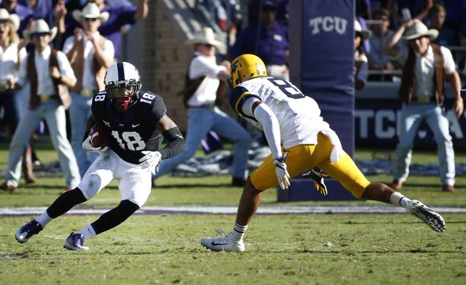 TCU safety Nick Orr (18) intercepts a pass in front of West Virginia wide receiver Marcus Simms (8) during the second half of an NCAA college football game Saturday, Oct. 7, 2017, in Fort Worth, Texas. TCU won 31-24. 