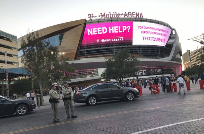 Metro Police officers stand outside T-Mobile Arena on the Las Vegas Strip before the start of the Los Angeles Lakers vs. Sacramento Kings basketball game on Sunday, Oct. 8, 2017.