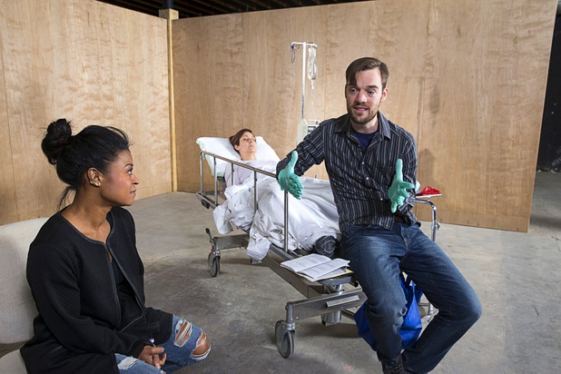 Sabrina Cofield (as nurse Susie Monhahan) and Andrew Calvert (as Dr. Jason Posner) rehearse a scene from "W;t" at the Public Fit Theatre, 100 South Maryland Parkway, Wednesday Oct. 11, 2017. Tina Rice plays the part of patient Vivian Bearing.