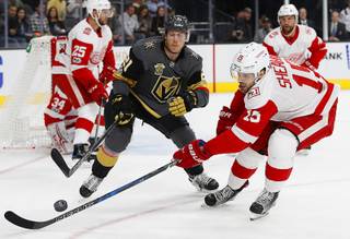 Vegas Golden Knights center Cody Eakin, left, and Detroit Red Wings center Riley Sheahan vie for the puck during the first period of an NHL hockey game Friday, Oct. 13, 2017, in Las Vegas. (AP Photo/John Locher)