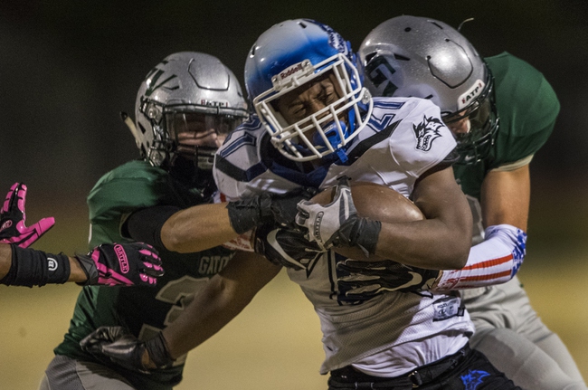 Basic's Dorian Ivan McAllister (21) is caught from behind by Green valley defenders in the Henderson Bowl high school football game Friday, October 13, 2017.