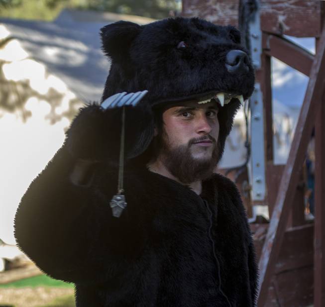 A bear-costumed guild member attempts to hypnotize attendees as they pass by during the Age of Chivalry Renaissance Festival at Sunset Park on Saturday, October 14, 2017.