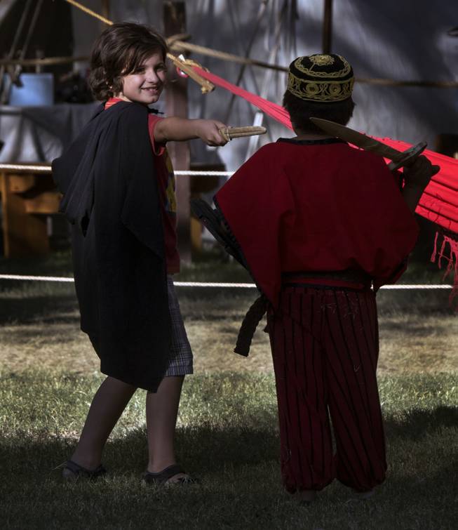 Kids have a pretend sword fight during the Age of Chivalry Renaissance Festival at Sunset Park on Saturday, October 14, 2017.