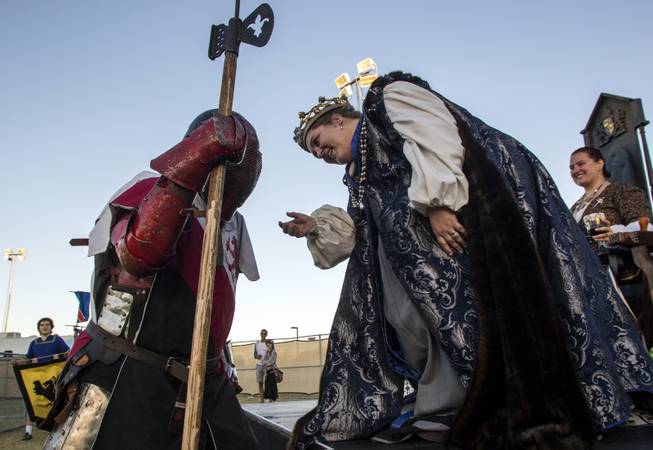 A knight is presented with a ceremonial flower by the Adrian Empire queen before doing battle during the Age of Chivalry Renaissance Festival at Sunset Park on Saturday, October 14, 2017.