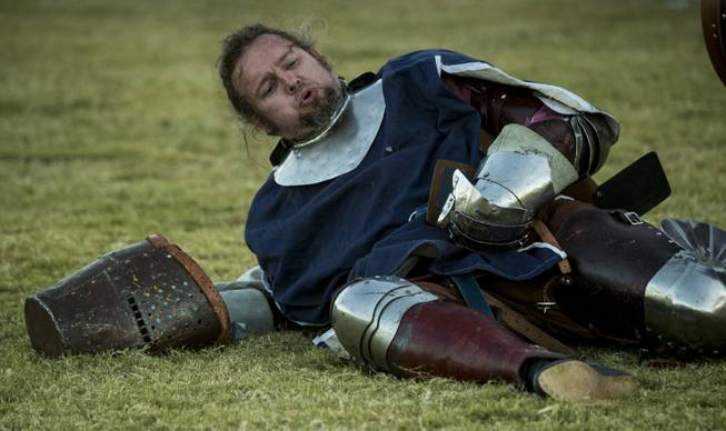 A knight is down and attempts to recover from battle in the Grand Melee on the Field of Honor during the Age of Chivalry Renaissance Festival at Sunset Park on Saturday, October 14, 2017.