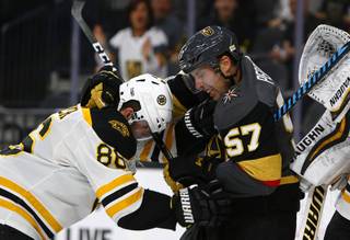 Boston Bruins defenseman Kevan Miller (86) gets into a fight with Vegas Golden Knights left wing David Perron (57) during a game against the Boston Bruins at T-Mobile Arena Sunday, Oct. 15, 2017.