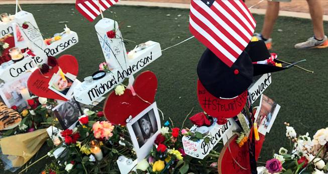 A cross with the name Michael Anderson is shown among the dozens of crosses at the Welcome to Las Vegas sign that memorialize the victims of the Oct. 1 mass shooting. Anderson died by other circumstances, but his name was inadvertently temporarily included in the memorial.