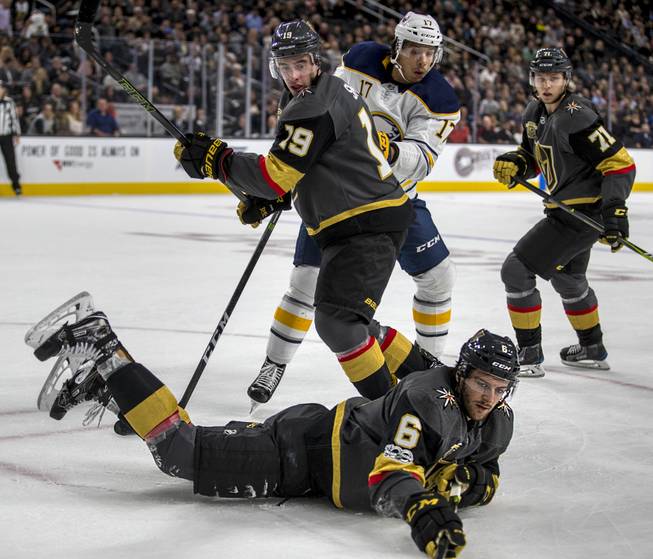 Vegas Golden Knights defenseman Colin Miller (6) goes down to the ice after a puck as teammate Vegas Golden Knights right wing Reilly Smith (19) defends against Buffalo Sabres center Jordan Nolan (17) during their game at the T-Mobile Arena on Tuesday, Oct. 17, 2017.