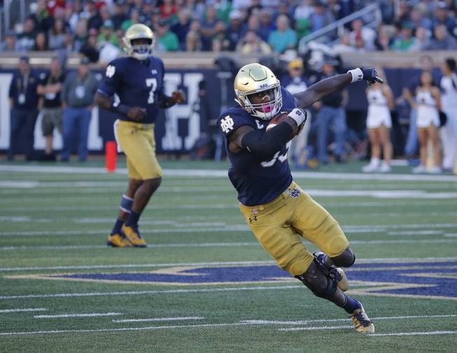 Notre Dame running back Josh Adams makes a cut on his touchdown run during the first half of an NCAA college football game against Miami (Ohio) Saturday, Sept. 30, 2017, in South Bend, Ind. 