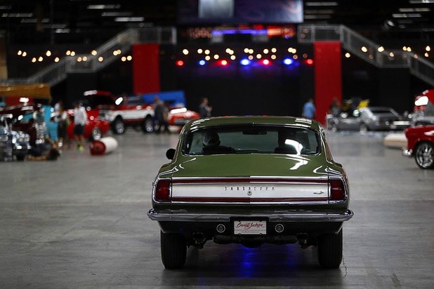 A 1969 Plymouth Barracuda is driven into the show floor after being detailed before the 10th annual Barrett-Jackson Las Vegas classic car auction at the Mandalay Bay Convention Center Wednesday, Oct. 18, 2017. The three-day auction begins Thursday.