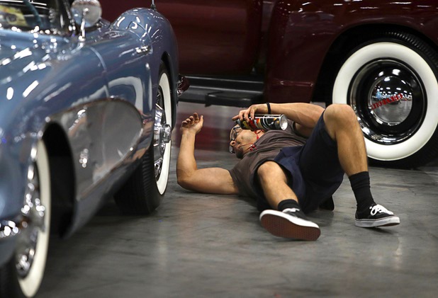Ian De La Pena of Mesa, Ariz. details a 1959 Chevrolet Corvette before the 10th annual Barrett-Jackson Las Vegas classic car auction at the Mandalay Bay Convention Center Wednesday, Oct. 18, 2017. The three-day auction begins Thursday.