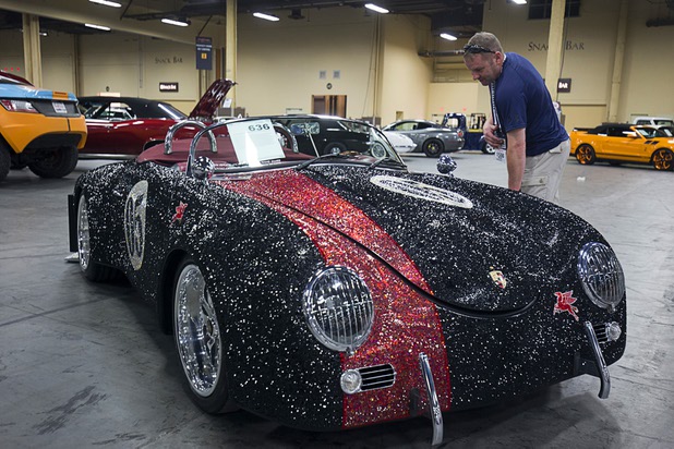 Mike Finigan of Omaha, Neb. looks over a 1956 Porsche Speedster Outlaw re-creation decorated with 247,000 Swarovski crystals before the 10th annual Barrett-Jackson Las Vegas classic car auction at the Mandalay Bay Convention Center Wednesday, Oct. 18, 2017. The three-day auction begins Thursday.