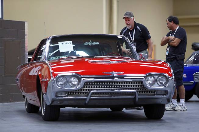 Dan Johnson, center, and Carl Kornago of Canada look over a 1962 Ford Thunderbird before the 10th annual Barrett-Jackson Las Vegas classic car auction at the Mandalay Bay Convention Center Wednesday, Oct. 18, 2017. Johnson has a 1928 Ford hot rod up for auction, he said.
