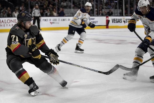 Vegas Golden Knights center William Karlsson (71) sends a puck past Buffalo Sabres center Jordan Nolan (17) during their game at the T-Mobile Arena on Tuesday, Oct. 17, 2017.