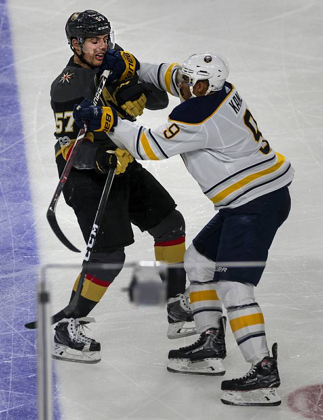 Vegas Golden Knights left wing David Perron (57) and Buffalo Sabres left wing Evander Kane (9) scrap a bit on the ice during their game at the T-Mobile Arena on Tuesday, Oct. 17, 2017.