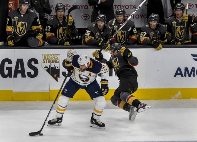 Buffalo Sabres center Ryan O'Reilly (90) clips Vegas Golden Knights left wing Tomas Nosek (92) sending him flying towards his team box during their game at the T-Mobile Arena on Tuesday, Oct. 17, 2017.
