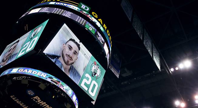 Boston Celtics forward Gordon Hayward is introduced to the crowd on the scoreboard from his hospital bed prior to the first quarter of an NBA basketball game against the Milwaukee Bucks, Wednesday, Oct. 18, 2017, in Boston. Hayward was injured in the season opener on Tuesday against the Cleveland Cavaliers. 