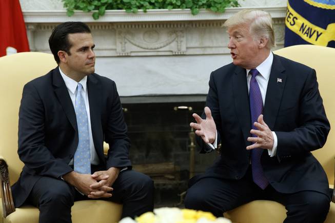 President Donald Trump meets with Gov. Ricardo Rossello of Puerto Rico in the Oval Office of the White House, Thursday, Oct. 19, 2017, in Washington.