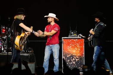 Iraq war veteran Corey Keller is invited onstage by Big & Rich at the Orleans Arena during a benefit concert to honor the victims of the Oct. 1 mass shooting, Thursday, Oct. 19, 2017.