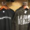 In this Thursday, Oct. 19, 2017 photo, T-shirts for sale with #VegasStrong hang at a gift shop at McCarran International airport in Las Vegas. Las Vegas has moved to rebrand itself after the Oct 1, 2017, shooting that killed 58 people and wounded hundreds of others. A salesman at the store said proceeds from the sales will go to an official fund to help shooting victims. 
