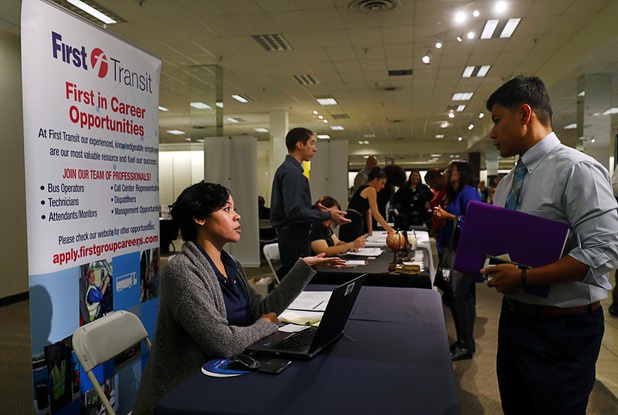 Rhonda Watson, a field recruiter for First Transit, talks to a job seeker during a job fair in the Boulevard Mall Wednesday, Oct. 25, 2017.